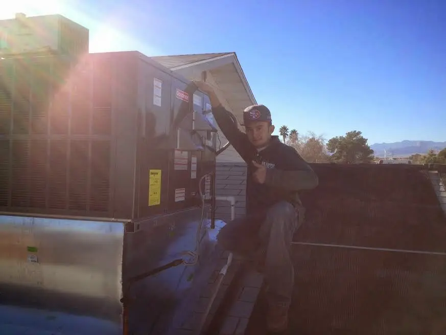 HVAC technician performing HVAC Inspection on a rooftop unit in West Memphis